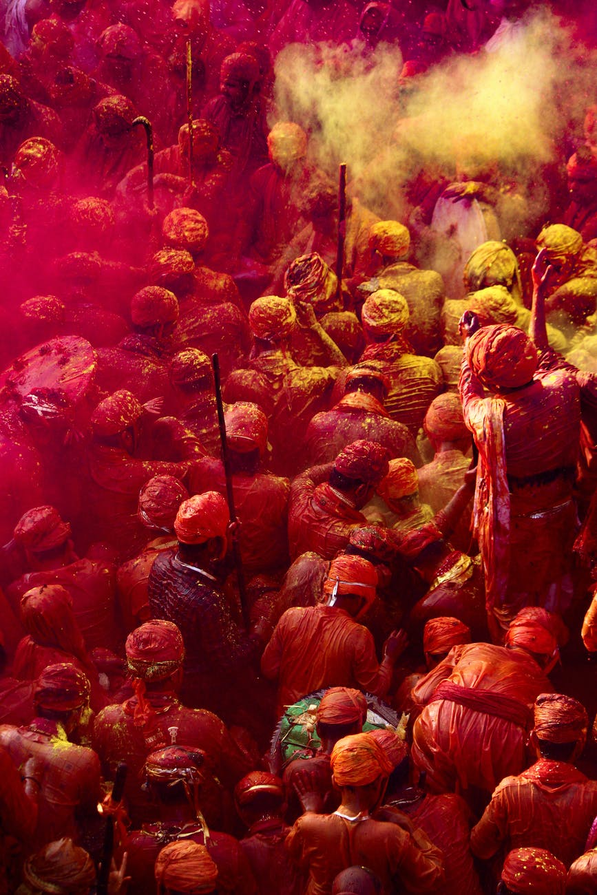 people covered with yellow and pink powder